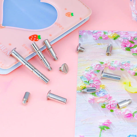 40 Pack Chicago Screws And Scrapbook Extension Posts Crafted From Hella Durable Solid Copper With Rust Proof Binding Hardware For Photo Albums, displayed on pink background.