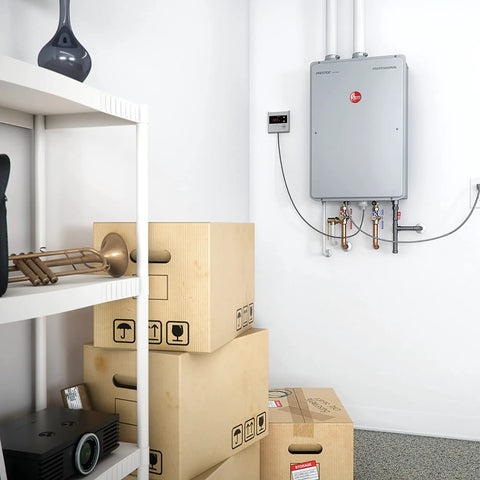 Skip The Clunky Tank For This High Efficiency Natural Gas Tankless Water Heater Delivering Straight Fire Whole Home Hot Water At 9.5 GPM With Smart Leak Alerts And Ultra Compact Footprint mounted in a storage area with boxes.