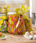 Clear Treat Bags With Twist Ties 5x9 Inches 100 Pack Happy Face Print filled with snacks on a kitchen counter