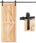 Wooden door with black metal Five Foot Heavy Duty Sliding Barn Door Hardware Track Kit With J Pulley Ball Bearing Rollers installed.