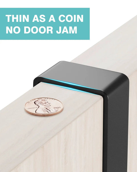 Close-up of no drill over the door mop and broom holder shown on door edge with coin for size reference. Thin as a coin, no door jam.