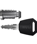 One Key Lock System Four Pack For Thule Gear Silver And Black key and lock cylinder close-up.