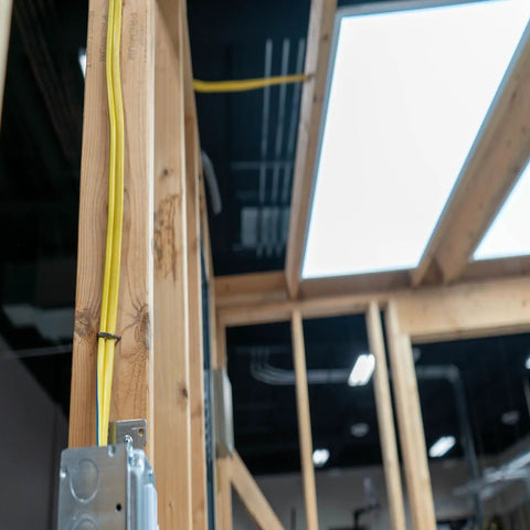 SIMPull Solid Indoor NM-B 10/3 With Ground Cable, 50 Ft Orange Coil installed on wooden frame for branch circuits