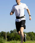 Man jogging with Hands Free Running Belt for Men and Women Secure Phone Pouch With Key Clip, fits 24.5 to 35.5 inch waists.