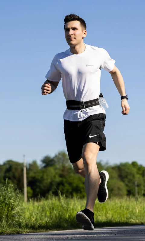 Man jogging with Hands Free Running Belt for Men and Women Secure Phone Pouch With Key Clip, fits 24.5 to 35.5 inch waists.