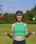 Person outdoors juggling colorful quad roller skate wheels with a park in the background.