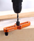 Kaas self-centering dowel jig, orange metal drill guide on wood, close-up view with drill bit.