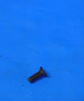 Close-up of Top Shelf S-959 Indexable Insert Screw For Precision Metalworking With 2-56 By.25 Threads on blue background.