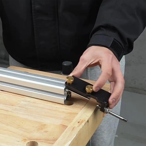 Dead Nuts Accurate Aluminum Profile Tapping Aid Tool positioning on a wooden surface for precise drilling on aluminum extrusions.