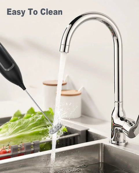 Handheld Frother Battery Powered Foam Maker Wand With Stainless Steel Whisk For Coffee Lattes Cappuccino Matcha Home Barista Grade Black Quick Froth In Seconds Easy Clean BPA Free Shaft being rinsed under a kitchen faucet