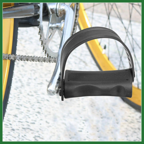 Close-up of non slip exercise bike pedals with straps, one half inch spindle for indoor and outdoor cycling, black pedal with secure strap system.