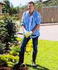 Person using Manual Twist Tiller For Gardening With Seventeen Inch Arc Handle And Ergonomic Grip Garden Claw Cultivator outdoors