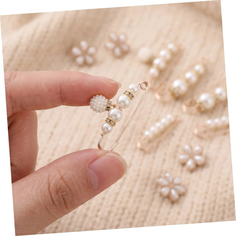 Eight Piece Pearl Waist Tightener Pins With Secure Locking Buckle System Fixes Loose Jeans And Skirts Instantly No Sew Hidden Dress Clips in hand.