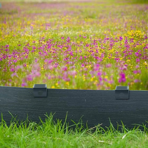 Black bender board installed in garden with colorful wildflowers, secured by 24 Pack 10 Inch Heavy Duty Metal Landscape Edging Stakes Galvanized Spikes