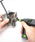 Person using Genesis 8V Variable Speed Rotary Tool Kit With Removable Lithium Ion Battery Pack And Charging Stand Includes 120 Volt ETL Wall Adapter And 64 Piece Universal Accessory Set Delivers 8 000 To 18 000 RPM on engine part