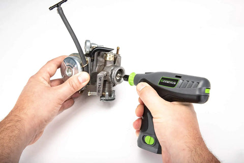Person using Genesis 8V Variable Speed Rotary Tool Kit With Removable Lithium Ion Battery Pack And Charging Stand Includes 120 Volt ETL Wall Adapter And 64 Piece Universal Accessory Set Delivers 8 000 To 18 000 RPM on engine part