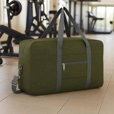 Go-To Foldable Travel Duffel Tote Bag Lightweight Carry On Personal Item for Women and Men Fits Underseat Airline Size 18x14x8 Inches Spirit Frontier Military Green No Shoulder Strap Included Durable Tear Resistant Gear displayed in gym setting.