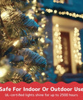 Close-up of Christmas tree illuminated with Clear 300 Count Christmas String Lights On Green Wire, 60 Ft Warm White Indoor Outdoor Use