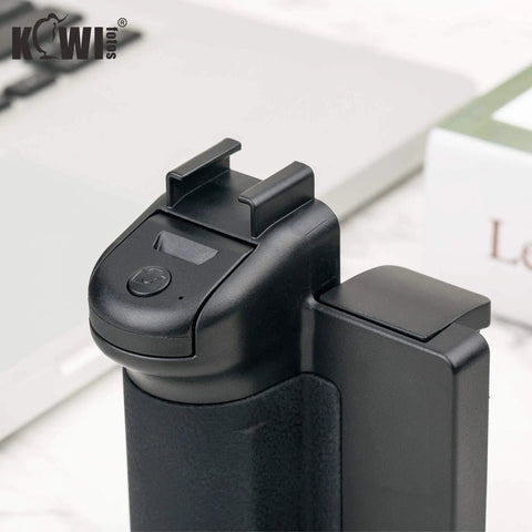 Close-up of compact phone camera grip handle with tripod mount remote shutter and cold shoe adapter for iPhone and Samsung smartphones.