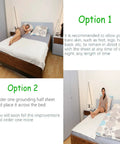 Person relaxing on bed with Grounding Mat With Grounding Cord And Organic Cotton Conductive Silver Fiber For Sleep Boost 77 By 88 Inches Grounding Sheets Real Earth Energy Sleep Aid For Restful Nights And Everyday Comfort.