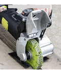 Close-up of Badass Heavy Duty Electric Slotting Machine And Groove Cutter with green blade cutting through concrete.
