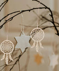 Wooden Dream Catchers DIY Kit With Hollow Design 50 Pcs Boho Style Wood Pendants For Creative Activities And Bedroom Wall Decor Fun Craft Supplies For Painting Crafting And Kids Projects; three unfinished wooden pendants on branches