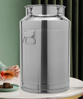 Built Tough Stainless Steel Food Storage Container With Airtight Silicone Seals And Secure Locking Clamps For Kitchen Pantry Organization And Keeping Rice Grains Fresh 12 Liter on a table next to a drink.