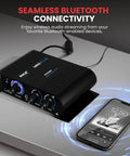 Wireless Bluetooth Home Audio Amp With 90W Dual Channel Power on a table, smartphone nearby showing streaming capability.