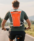 Cyclist wearing Hydration Running Pack For Men And Women Go To Lightweight Water Backpack Vest with Bottle Holder Pouch outdoors.