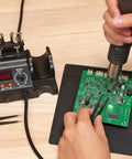 Compact Entry Level Hot Air Rework Station Kit With Integrated Design in use on a circuit board with 3 hot air nozzles visible