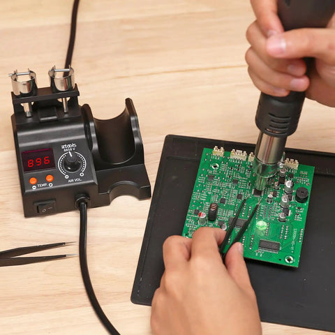 Compact Entry Level Hot Air Rework Station Kit With Integrated Design in use on a circuit board with 3 hot air nozzles visible