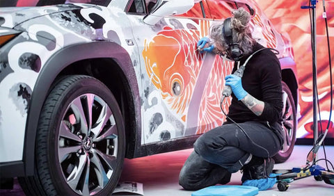 Artist using Reinforced Polyurethane Air Hose One Quarter Inch By One Hundred Feet Pink Transparent With Swivel Quick Coupler for car painting
