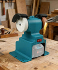 Get Your Hands on This Badass Cordless Mini Bench Grinder with two wheels and a Makita battery on a workbench.
