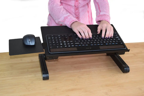 Hands adjusting WorkEZ Adjustable Keyboard Stand For Desk Ergonomic Keyboard And Mouse Riser With Tilt And Height Control