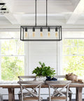 Modern Farmhouse Linear Chandelier In Matte Black For Kitchen Island And Dining Room displayed above a wooden table in a bright room