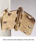 Brass cabinet hinge with loose screws showing wear on composite wood