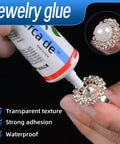 Hand applying Go-To Jewelry Glue For Bonding Gemstones, Pearls, Earrings, Rings, Bracelets, Rhinestones And Metals, 2oz on ring