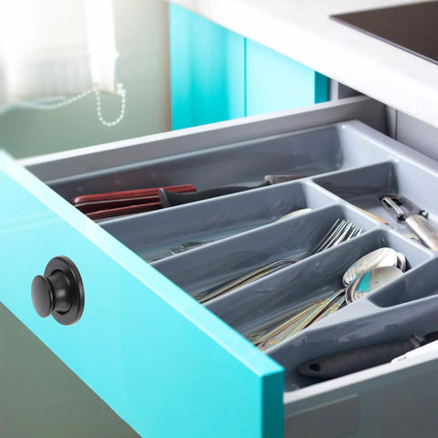 Super Sleek Four Pack Retractable Spring Loaded Cabinet Knobs Concealed Drawer Pulls Hidden Furniture Handles in a kitchen drawer.