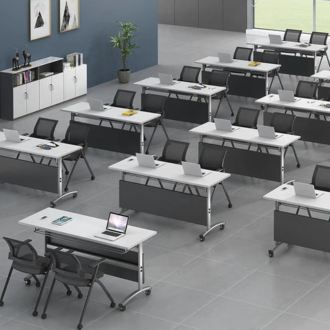 Game Changer Folding Mobile Conference Table With Privacy Panel And Heavy Duty Locking Casters Flexible Workstation Setup For Home Office Or Classroom Use In Packs Of Four Tables in a modern classroom layout with laptops.