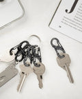 S Biner MicroLock Stainless Steel Key Holder Carabiner Clip Set Of 5 With Locking Gates on keychains, keys on a marble background