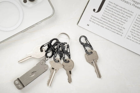 S Biner MicroLock Stainless Steel Key Holder Carabiner Clip Set Of 5 With Locking Gates on keychains, keys on a marble background