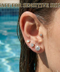 Close-up of ear wearing Gold Zircon Nose Studs 20 Piece Set Dope Threadless Flat Back Nose Jewelry 18G 20G in pool setting