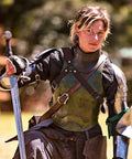 Person in armor with Old School Medieval Leather Back Sword Frog Holster For Renaissance Viking Warrior Costumes, sword in hand.