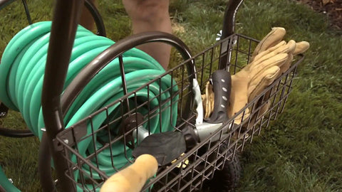 Heavy Duty Four Wheel Hose Reel Cart With 250 Foot Capacity, Steel Frame, Built In Garden Basket in use on lawn