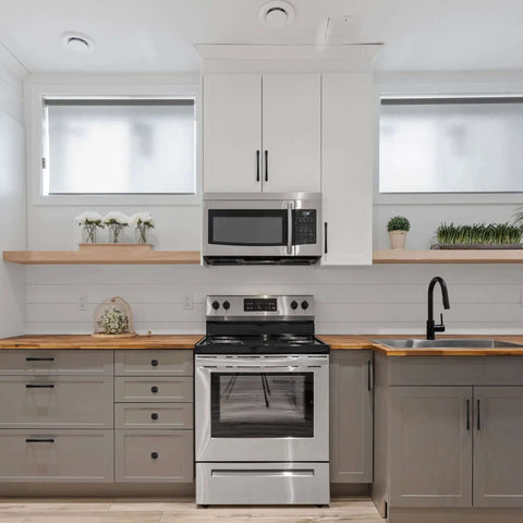 Modern kitchen with stainless steel appliances, featuring Badass Matte Black Cabinet Handles 5 Inch 128mm Kitchen Drawer Pulls.