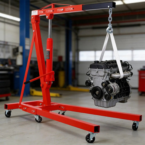 Hella Sturdy Heavy Duty Hydraulic Engine Hoist Crane Two Ton Four Thousand Pounds Capacity Folding Cherry Picker With Six Swivel Casters For Garage Work Red lifting an engine in a workshop.