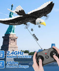 Remote Control Eagle Plane For Newbies And Kids 2.4GHz 2CH RC Airplane flying near Statue of Liberty, includes controller