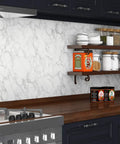 Ultra Wide 36 By 197 White Marble Peel And Stick Countertop Wallpaper in kitchen with dark cabinets and wooden shelves.