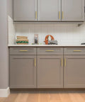 Modern kitchen with 25 Pack 5 Inch Square Cabinet Handles In Brushed Brass Finish Stainless Steel Kitchen Hardware Pulls With 5 Inch Hole Center For Cabinets Gold Durable DIY Drawer Wardrobe Updates installed on gray cabinets.
