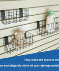 Ultimate Slatwall Storage Kit For Garage And Shop Organization with 3 wire baskets mounted on a slat wall holding items